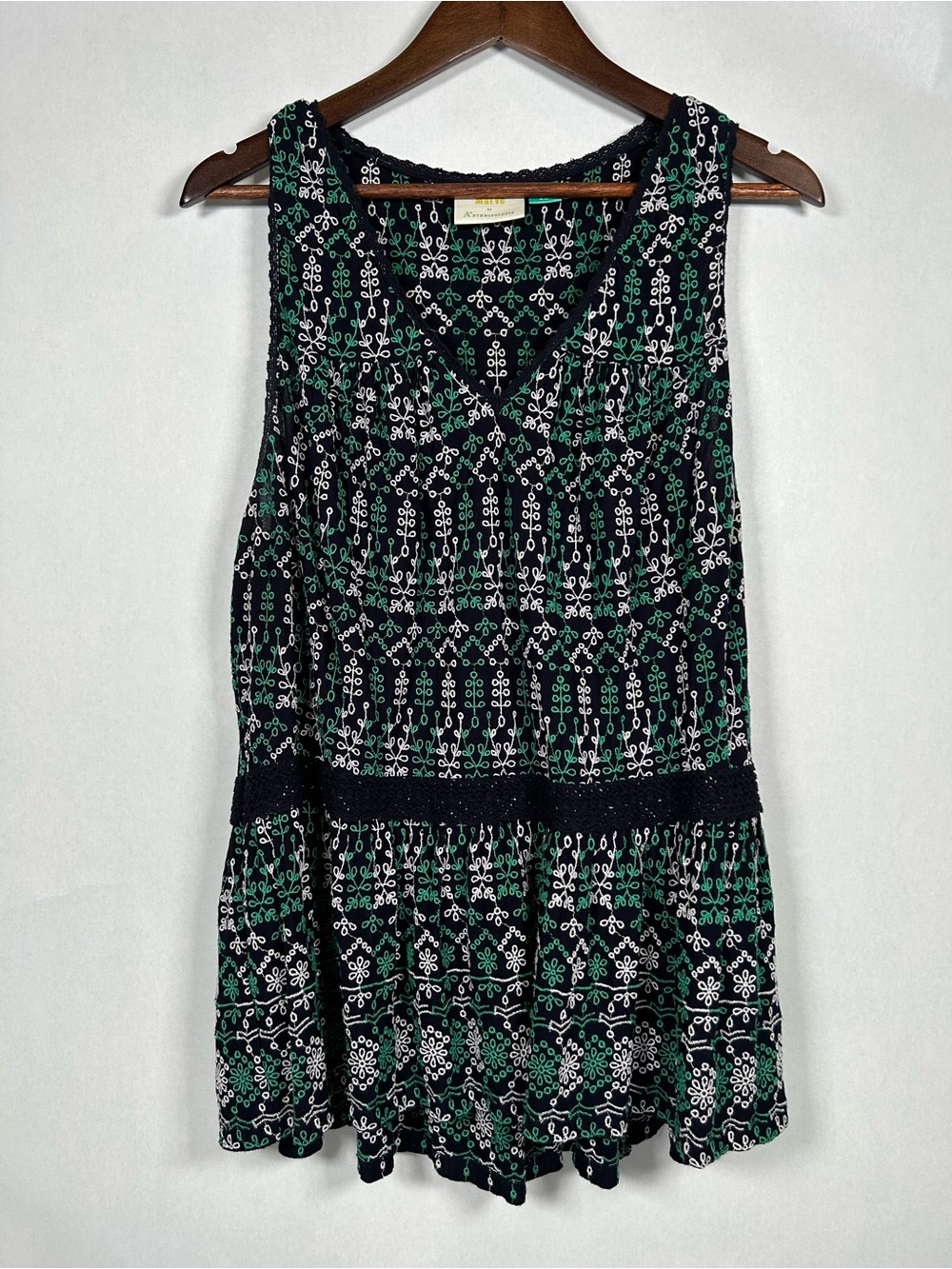 Anthropologie Maeve Cammie embroidered floral peplum top in blue and green.